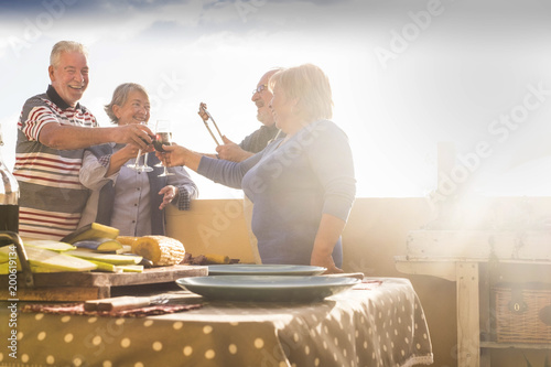 senior group barbeque on the terrace outdoor photo