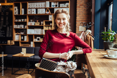 Portrait of gorgeous young pleasent business woman nice to meet you in modern loft cafe interior. photo