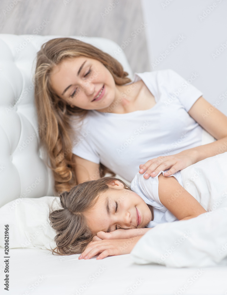 Happy mother wakes up her daughter in the morning Happy mother wakes up her daughter in the morning