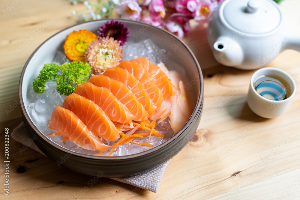 Salmon sashimi slice fresh serve on ice with tea, Japanese style Salmon sashimi slice fresh serve on ice with tea, Japanese style