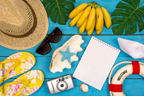 Top view of beach summer accessories with copy space. Traveler accessories. Summer background. Summer beach vacation concept. Flat lay, top view.