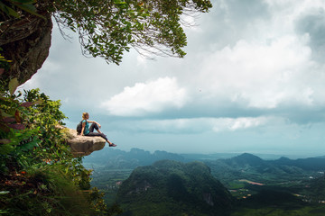 Hiker rest on a cliff,woman enjoy landscape of nature
