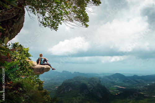 Hiker rest on a cliff,woman enjoy landscape of nature photo