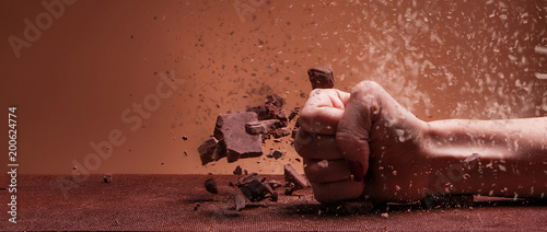 Female hand destroying chocolate and diet - Letterbox, dispersion effect photo