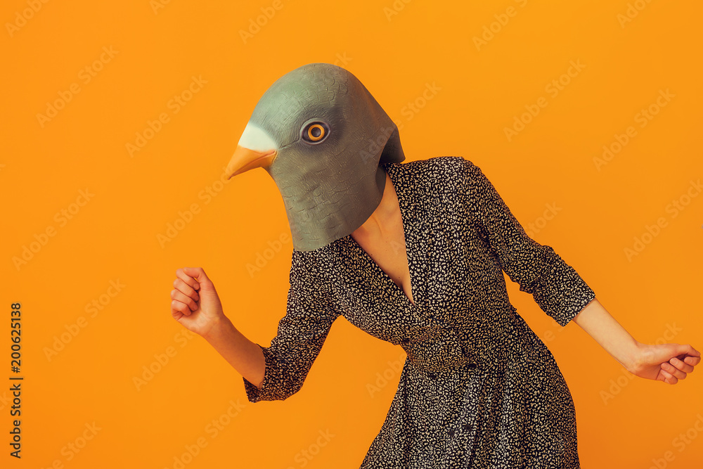 Woman portrait wearing pigeon mask and going to run Stock Photo | Adobe  Stock