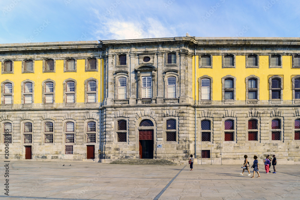 Porto, Portugal. August 12, 2017 Stone facade of the Portuguese Center of Photography in the square called Martyrs of the Fatherland with tourists strolling. It used to be the city jail