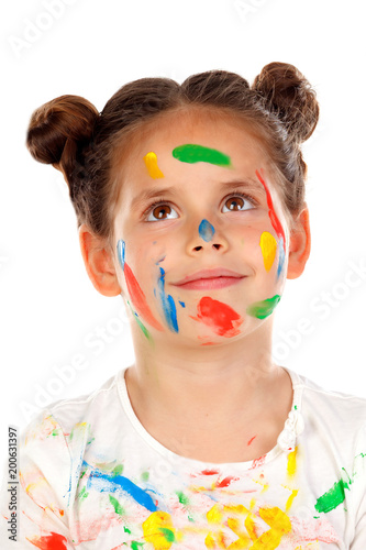Pensive girl with hands and face full of paint isolated on a white background