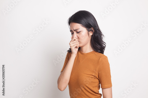 Young Asian woman  holding her nose because of a bad smell. © halfbottle