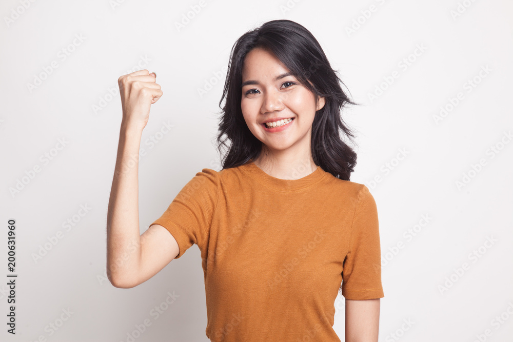 Successful young Asian woman hold fist up. Successful young Asian woman hold fist up.