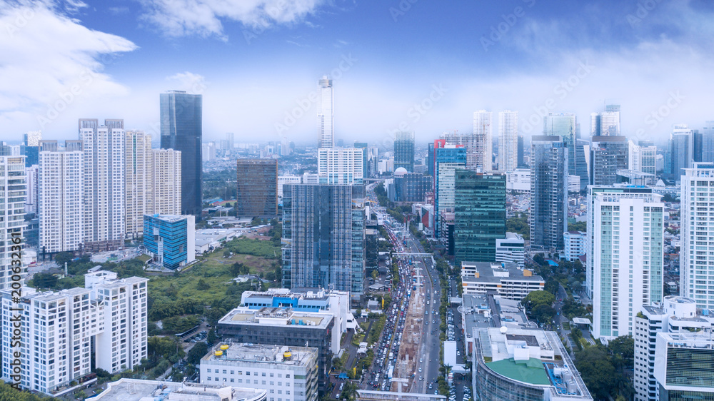 Fototapeta premium Traffic on busy road with high buildings