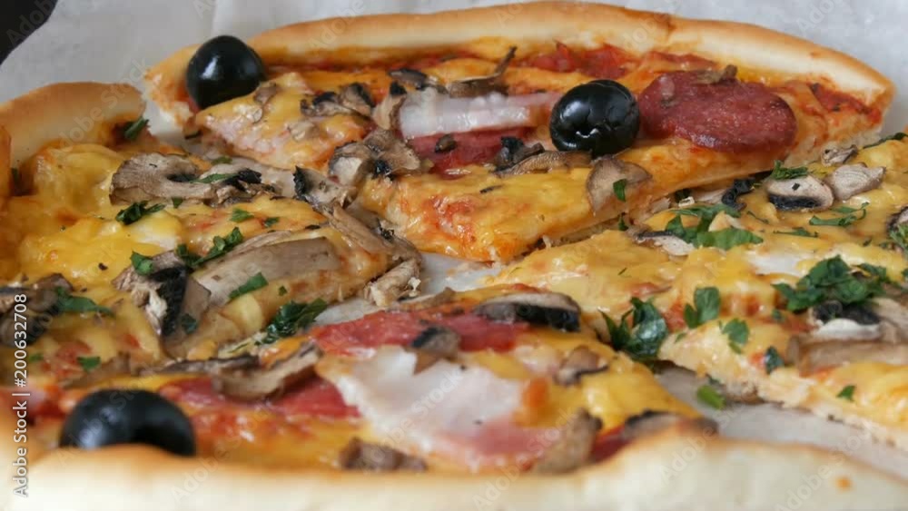 Many pieces of the pizza with different fillings, olives, chicken, mushrooms, cheese, bacon, salami, greens Many pieces of the pizza with different fillings, olives, chicken, mushrooms, cheese, bacon, salami, greens
