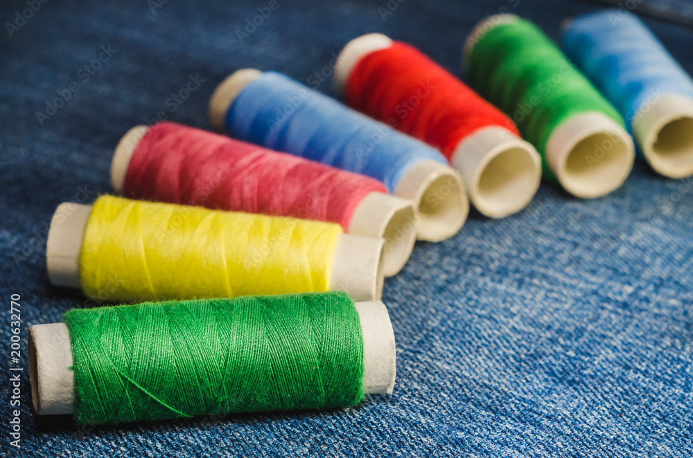 Spools of multi-colored threads, arranged in a semicircle Spools of multi-colored threads, arranged in a semicircle