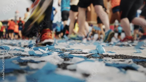 Wallpaper Mural Super low perspective shot with soft focus on flying confetti blown in wind, and crowd pack of marathon participants and runners run on competition day, concept sports festivities and heathy lifestyle Torontodigital.ca