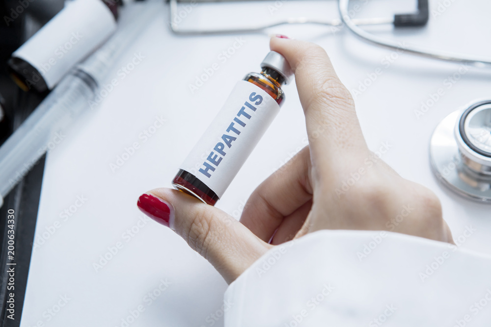 Hand of unknown doctor holding Hepatitis word Hand of unknown doctor holding Hepatitis word