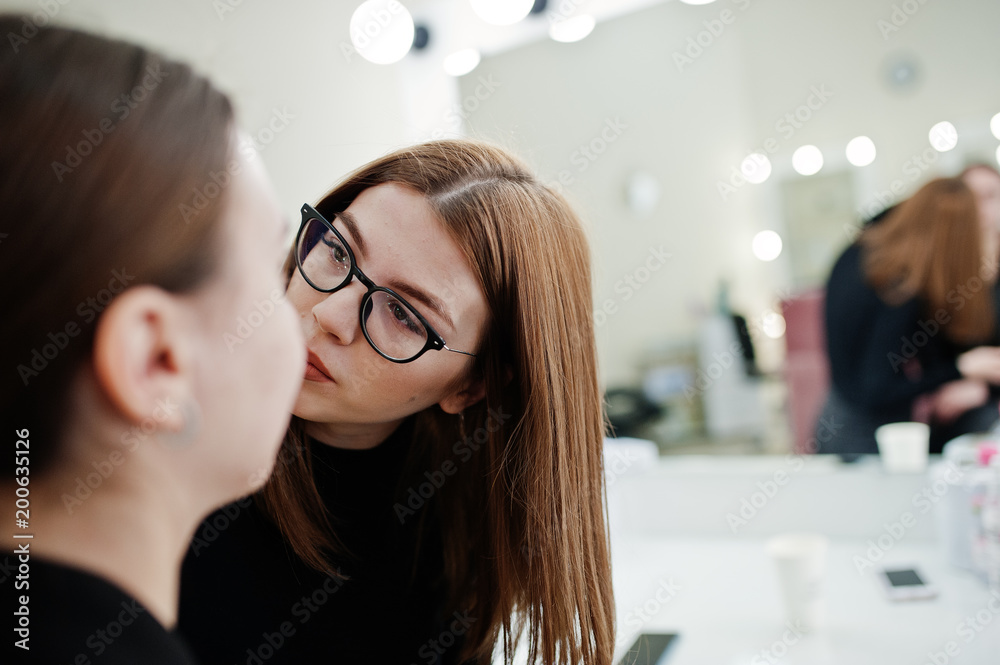 Make up artist work in her beauty visage studio salon. Woman applying by professional make up master. Beauty club concept. Make up artist work in her beauty visage studio salon. Woman applying by professional make up master. Beauty club concept.