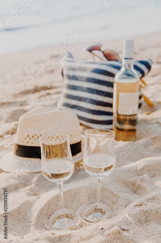 Fototapeta Naklejka Na Ścianę i Meble -  Picnic background with bag, grape and white wine by blue sea