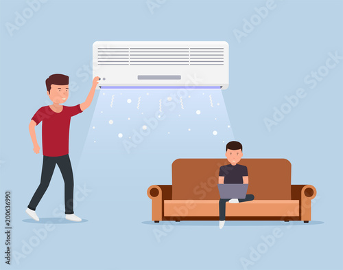 Home air conditioning, room with cooling, man on sofa with laptop and air conditioning in indoors.
