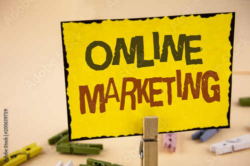 Wallpaper Mural Handwriting text writing Online Marketing. Concept meaning Marketing digital advertising social media e-commerce written on Yellow Sticky Note Paper on the plain background Wooden Clips. Torontodigital.ca