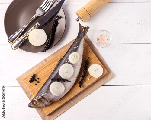Delicious Salted Herring with Onion and Pepper on the Wooden Desk White Wooden Background Rustic Style Top View Copy Space