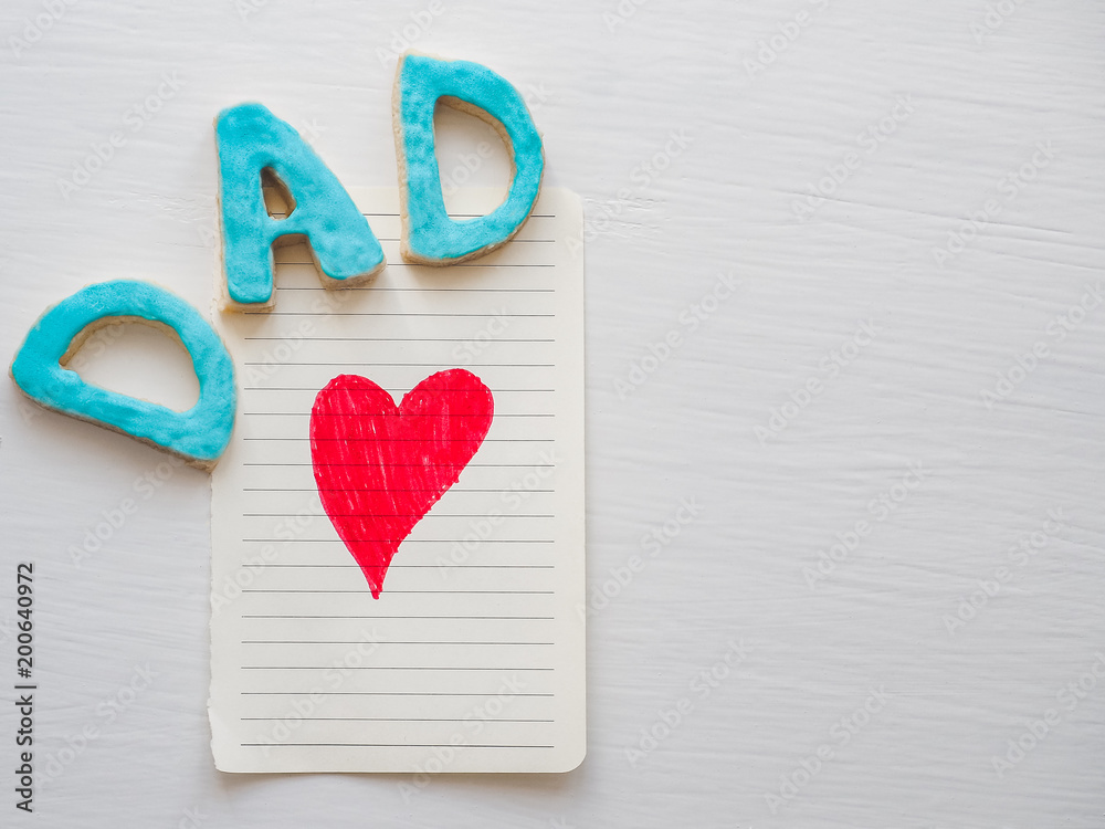 Sweet, cute kitten and the word DAD on a white, isolated background. Preparation for Father's Day Sweet, cute kitten and the word DAD on a white, isolated background. Preparation for Father's Day