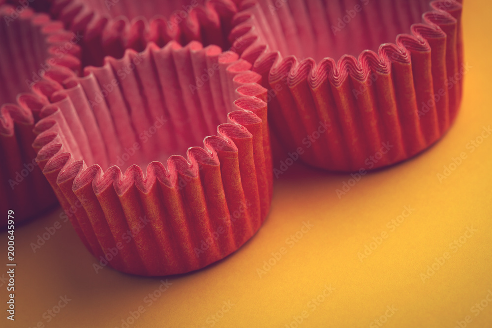 arrangement of pink small cupcake tray holders on yellow arrangement of pink small cupcake tray holders on yellow