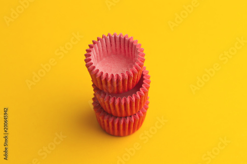 arrangement of pink small cupcake tray holders on yellow