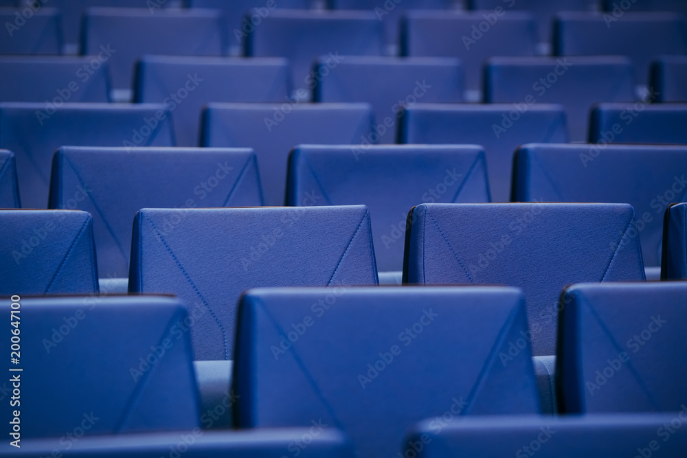 Fototapeta premium Many rows of empty armchairs. Blue, elite seats, comfortable armchairs. Conference room, theater or cinema.