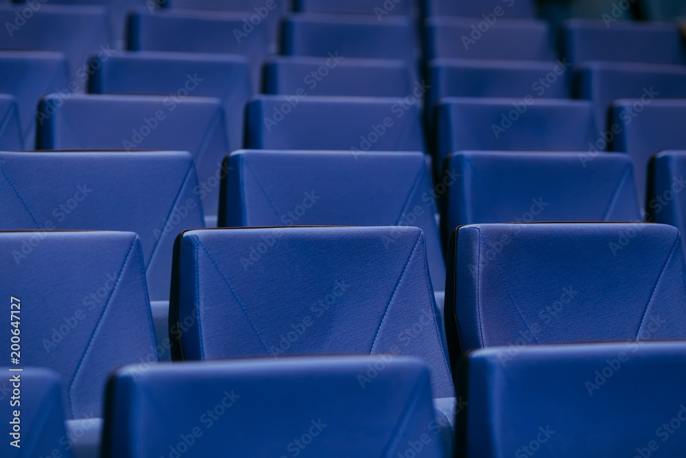 Fototapeta premium Many rows of empty armchairs. Blue, elite seats, comfortable armchairs. Conference room, theater or cinema.