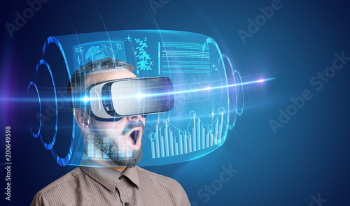 Amazed businessman with high tech 3D projection in front of him 