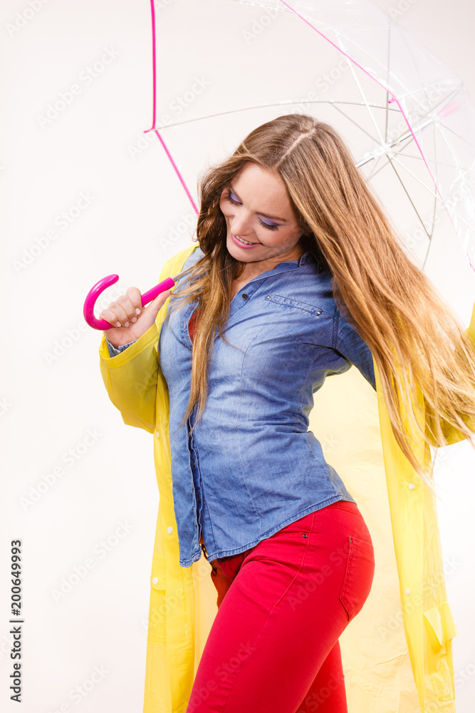 Woman wearing waterproof coat under umbrella Woman wearing waterproof coat under umbrella
