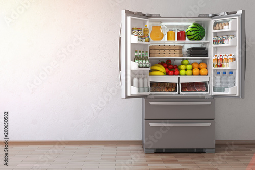 Open fridge  refrigerator full of food in the empty kitchen interior. photo
