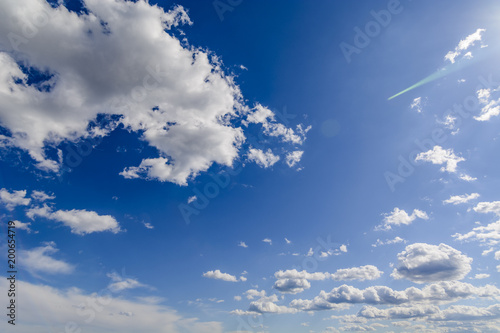 Sunny blue sky with clouds  in spring time .