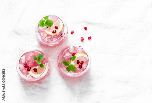 Pomegranate tequila cocktail. Summer light alcoholic drink, cooling aperitif. On light background, top view, free space. Flat lay