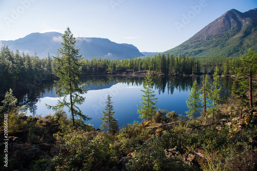 Wonderful lake wide panorama. Scenic summer landscape  mountains and blue cloudy sky at background. Eastern Sayan  Buryatia  Russia.