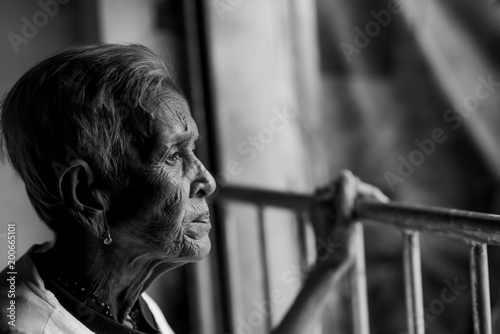 The old woman's felling lonely. ,she's senior woman in family and the elderly.