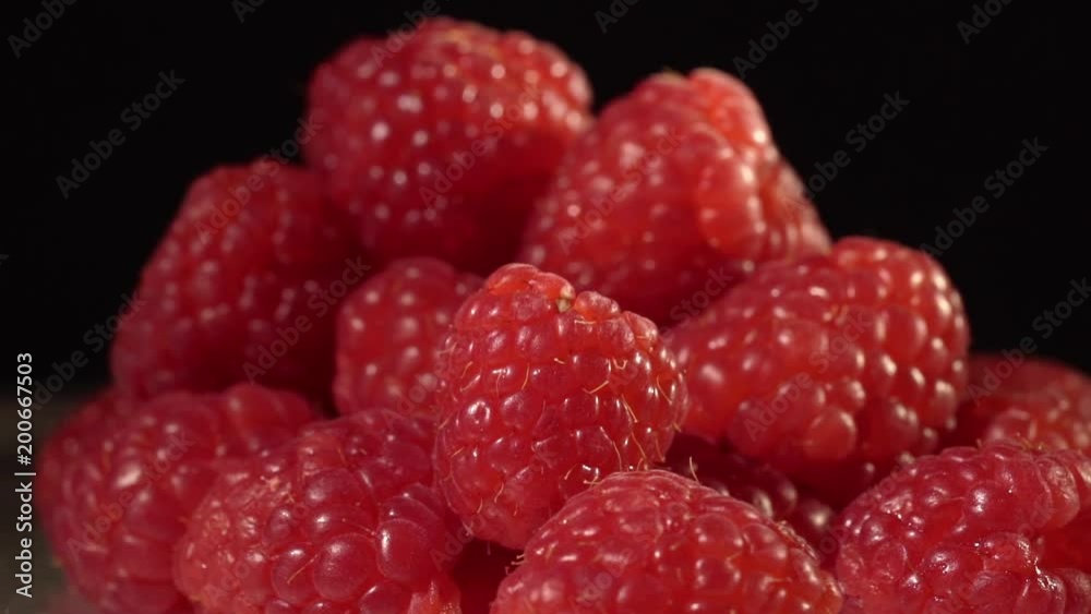Raspberry on black background close up isolated circling Raspberry on black background close up isolated circling