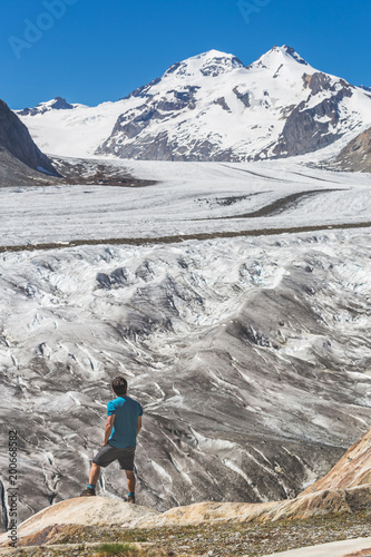 Lone male climber looking out, Aletsch Glacier, Canton Wallis, Switzerland
