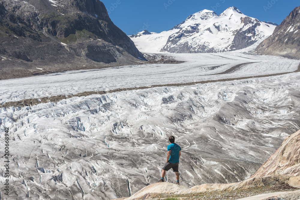 Lone male climber looking out, Aletsch Glacier, Canton Wallis, Switzerland