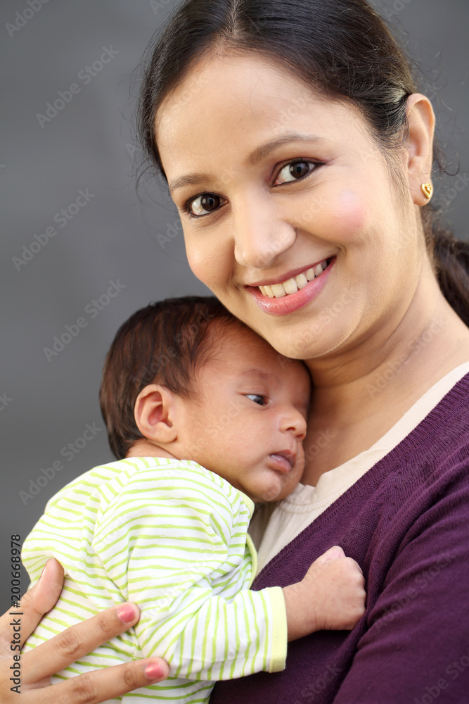 Cheerful mother holding newborn baby Cheerful mother holding newborn baby