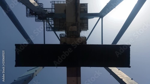 gantry crane unloading 40 feet container at the port - bottom view