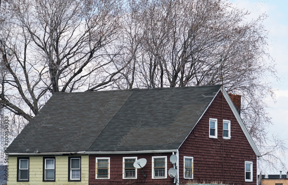 old house exterior with tree branch in winter old house exterior with tree branch in winter