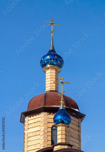 beautiful wooden Church with blue domes with stars photo