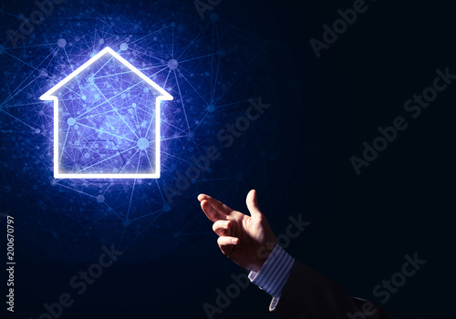 Conceptual image with hand pointing at house or main page icon o