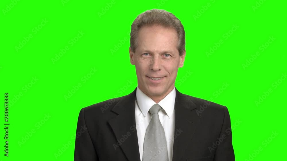Portrait of cheerful mature businessman. Man in suit facial expressions, mouth motion. Green hromakey background for keying. Portrait of cheerful mature businessman. Man in suit facial expressions, mouth motion. Green hromakey background for keying.