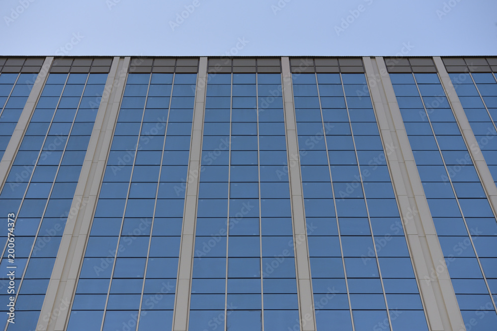 Fototapeta premium The glass surface of the building. Perspective. Building with glass surface and reflection