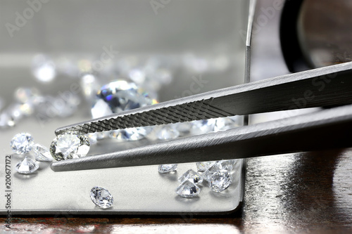 Bild auf Leinwand brilliant cut diamond held by tweezers