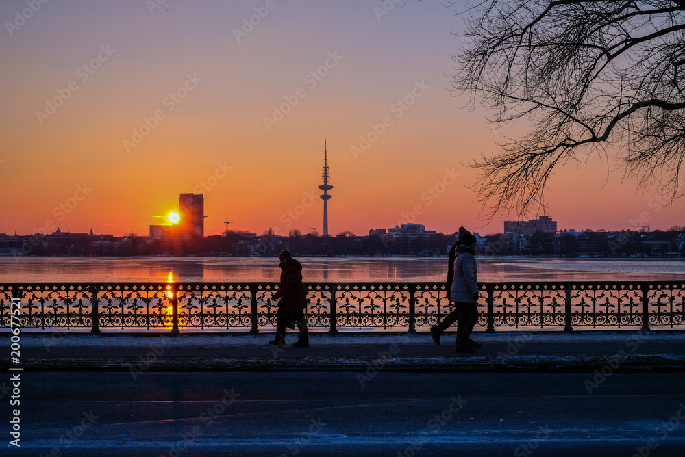 sunset on the coast in Hamburg, Germany, TV tower, peopleon the bridge