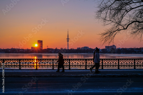 sunset on the coast in Hamburg, Germany, TV tower, peopleon the bridge © Lina
