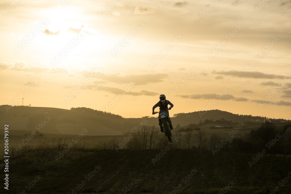 Fototapeta premium Motorcyclist riding off road during sunset. Slovakia
