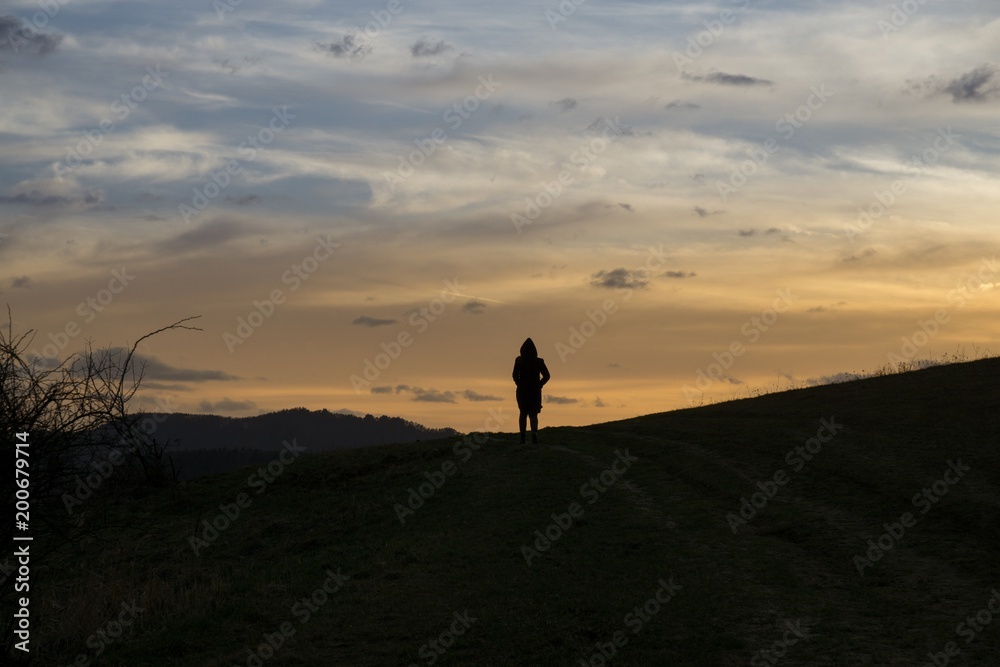People on the horizon of meadow during sunset. Slovakia